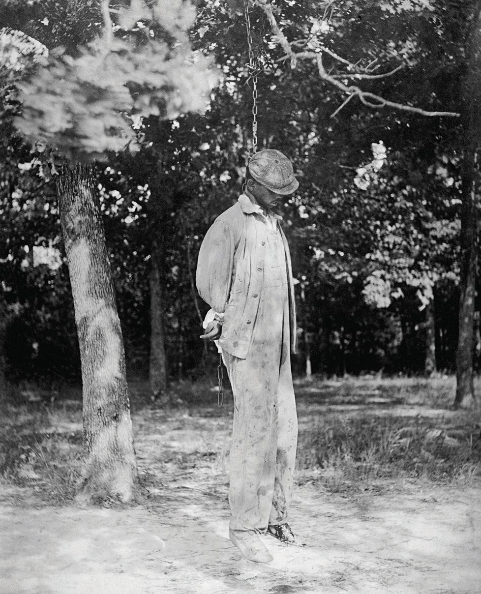 An African American man hanging from a noose. A victim of a lynching