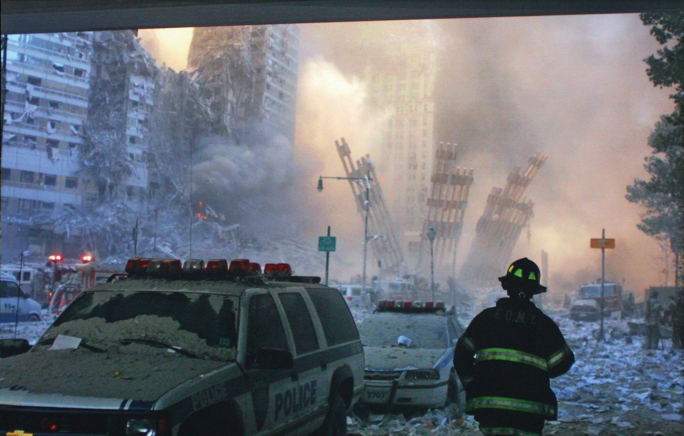 A firefighter standing in the remnants of the world trade center, after both towers collapsed