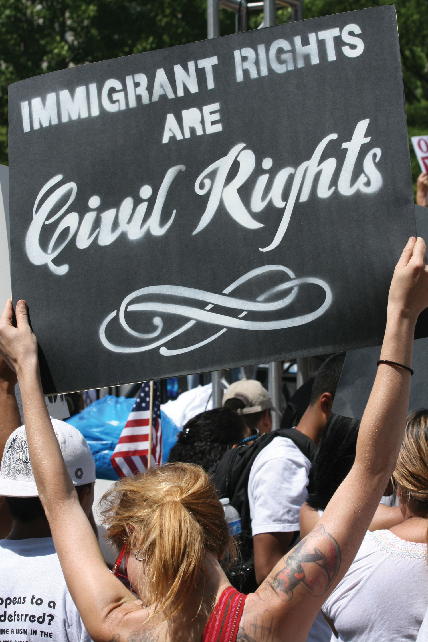 A protest of Immigration Reform. A woman holds up a sign