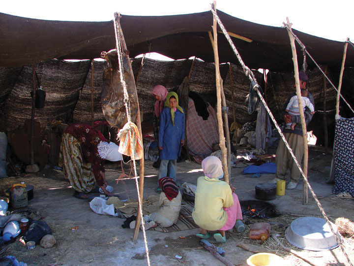 A photo illustrating the Nomad's Simple Life. Tarps are supported by sticks and ropes to create shade from the devastation caused by greenhouse gases