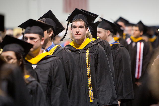 A line of college graduates in their gowns
