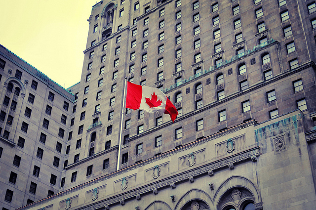 A Canadian Flag outside of a building in Toronto