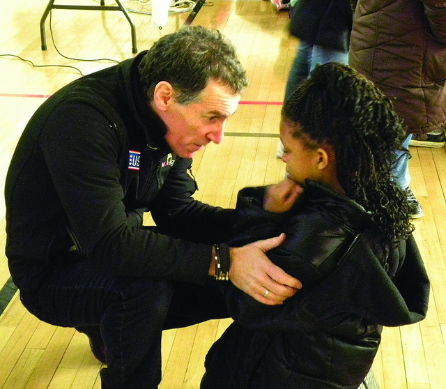 A man harshly disciplining a young girl