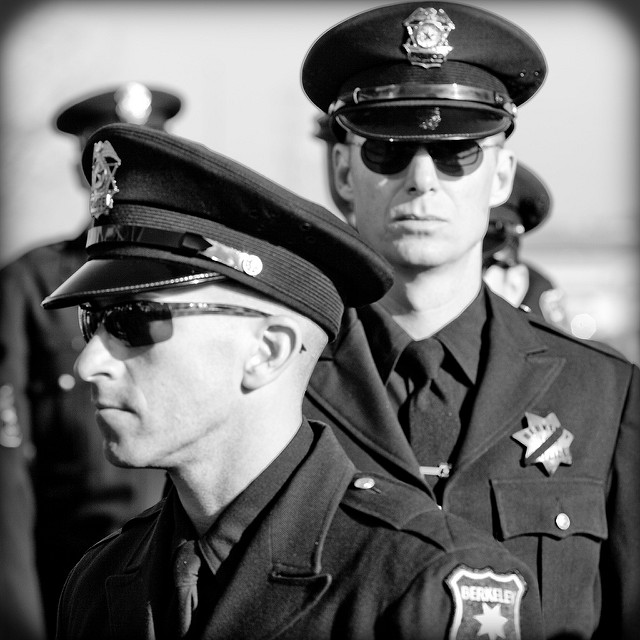 Cops stand in line at an Oakland Police Memorial