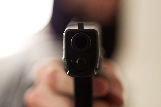 A glock (pistol) pointed straight at the camera