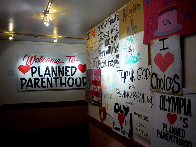 The entrance of a Planned Parenthood, covered in many pro choice posters