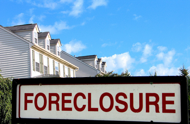 A Foreclosure sign in front of a house
