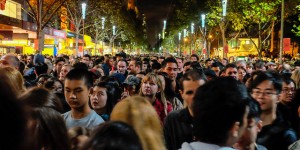 A crowd of people on a lit up street