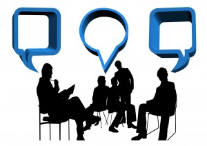 Exchange of ideas, many silhouettes of many different people with speech bubbles by each head