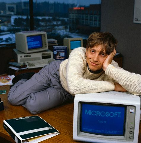 Bill Gates, CEO of Microsoft, reclines on his desk in his office soon after the release of Windows 1.0. 1985 Bellevue, Washington, USA