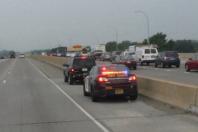 A state trooper pulling someone over on the highway