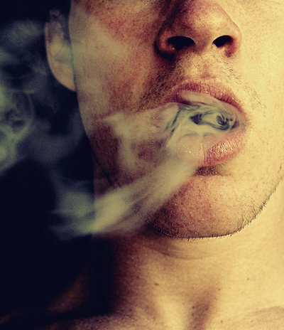 A man exhaling smoke