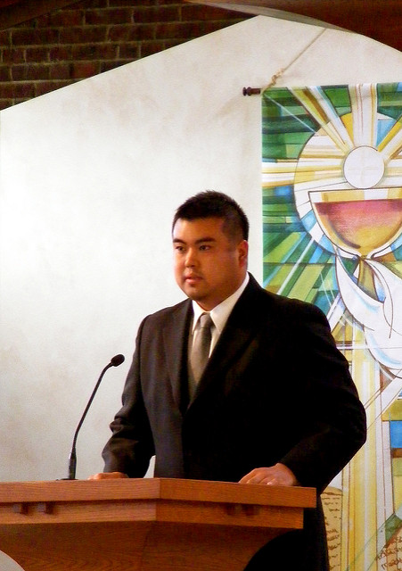 A man giving a speech at an altar