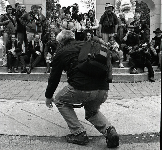 A man entertaining a crowd on the street