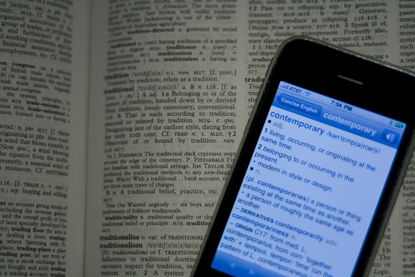 Dictionary on a phone resting on a print dictionary