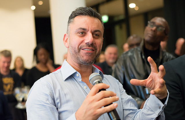 A man with a microphone speaking at an event