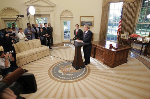 George W. Bush speaking to the press and John G. Roberts