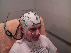 A young man wearing an EEG