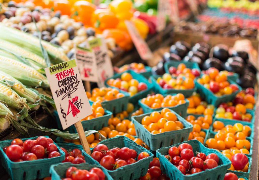 Containers with cherry tomatoes (red and yellow) at a market.