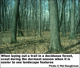 When laying out a trail in a deciduous forest, scout during the dormant season when it is easier to see landscape features