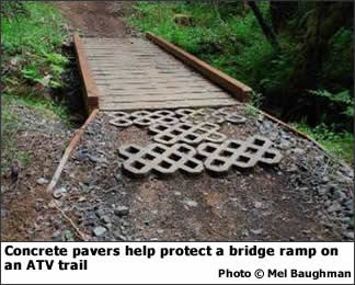 Concrete pavers help protect a bridge ramp on an ATV trail