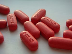 This photo shows several red capsule pills.