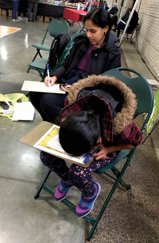Adult and child writing together