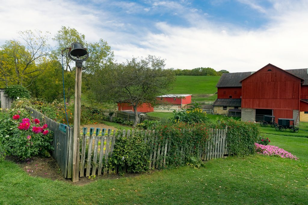 Farm with garden, flowers, and fields.