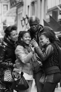 Family looking at a phone taking a selfie.