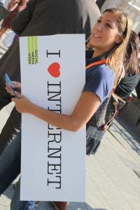 Woman holding a sign that says, 'I love internet.'