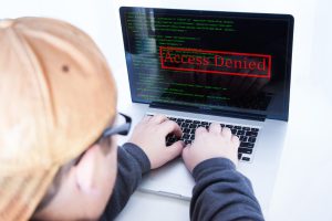 Child at computer with screen showing 'Access Denied.'