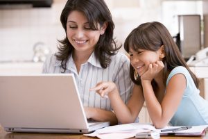 Mother and daughter looking at a laptop computer