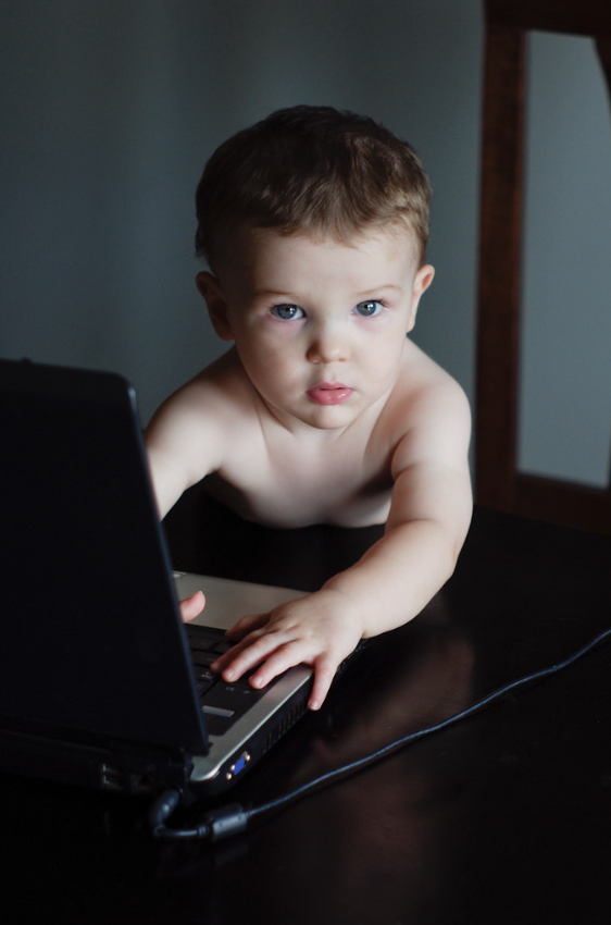 Young child using a laptop.