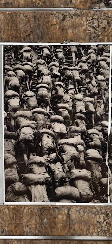 Image of numerous people climbing ladders while carrying bags over their shoulders