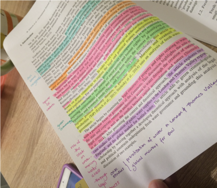 image of a page in a textbook in which sentences have been marked with different colors using highlighters